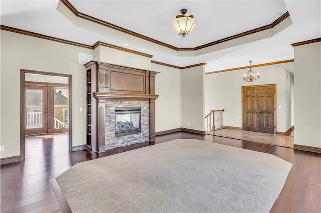 unfurnished living room with ornamental molding, dark hardwood / wood-style floors, and an inviting chandelier