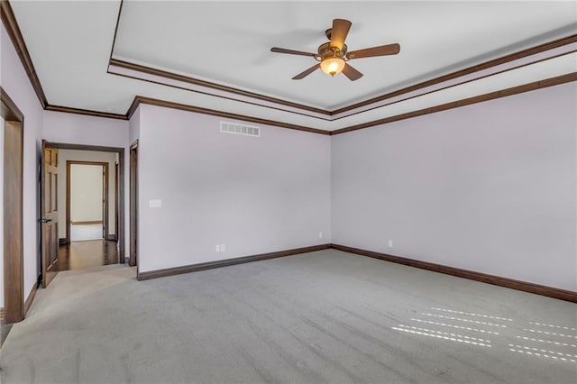 carpeted spare room with ceiling fan and crown molding