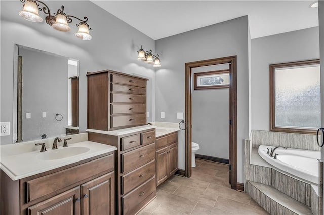 bathroom featuring vanity, toilet, tile patterned floors, and tiled tub