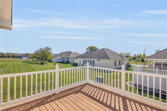 wooden terrace featuring a yard