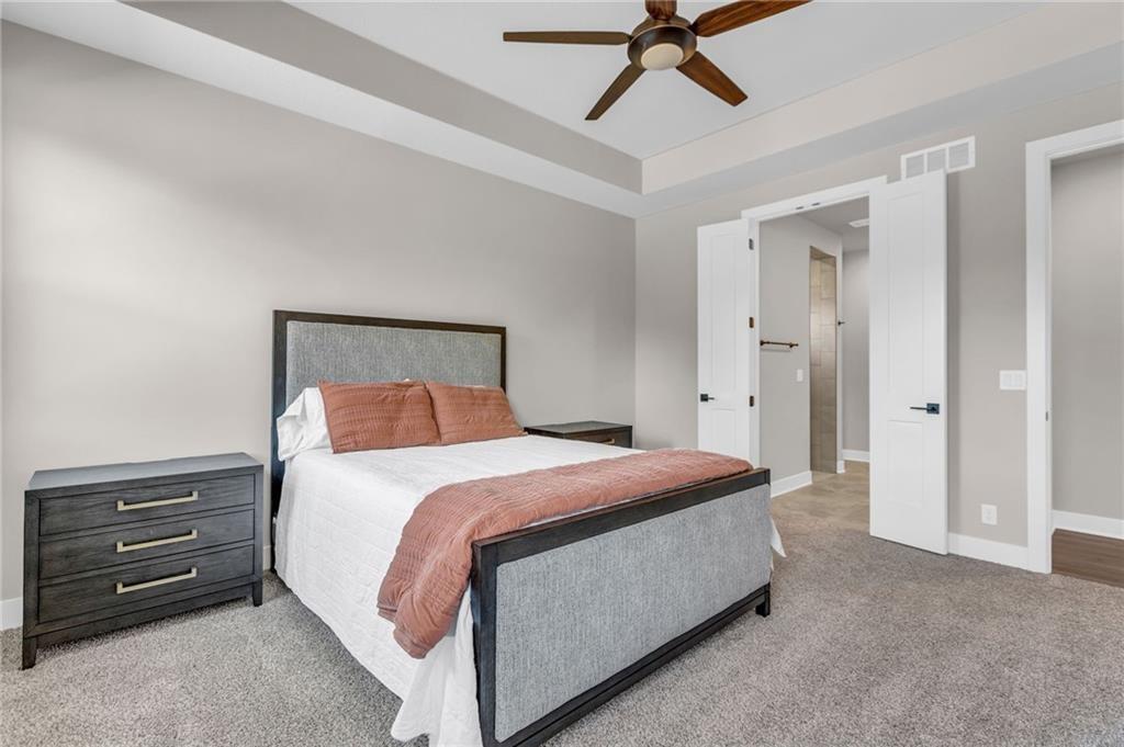 carpeted bedroom featuring ceiling fan