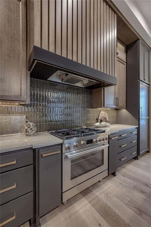 4511 W 136th St, Leawood, KS 66224 - kitchen with stainless steel gas range, gray cabinets, backsplash, and light wood-type flooring