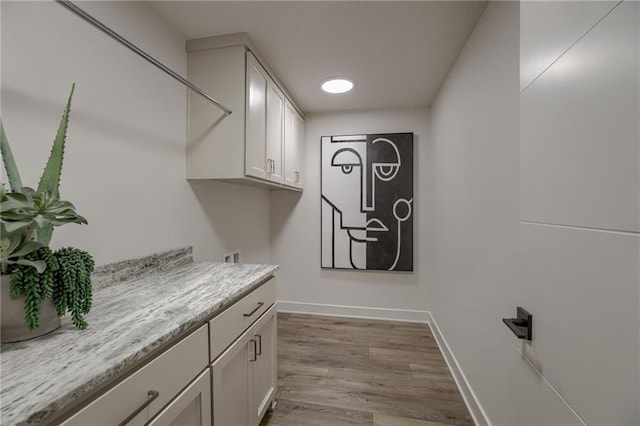 4511 W 136th St, Leawood, KS 66224 - clothes washing area with cabinet space, washer hookup, wood finished floors, and baseboards