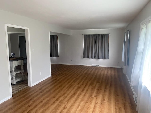 unfurnished room featuring hardwood / wood-style flooring and plenty of natural light