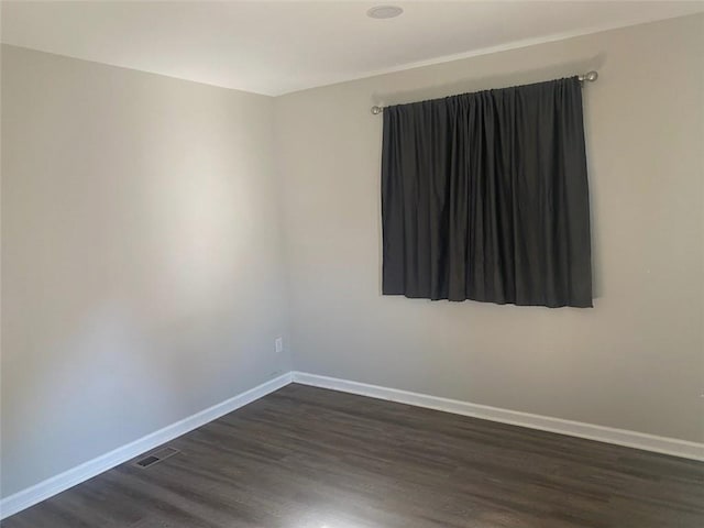 empty room featuring dark hardwood / wood-style flooring