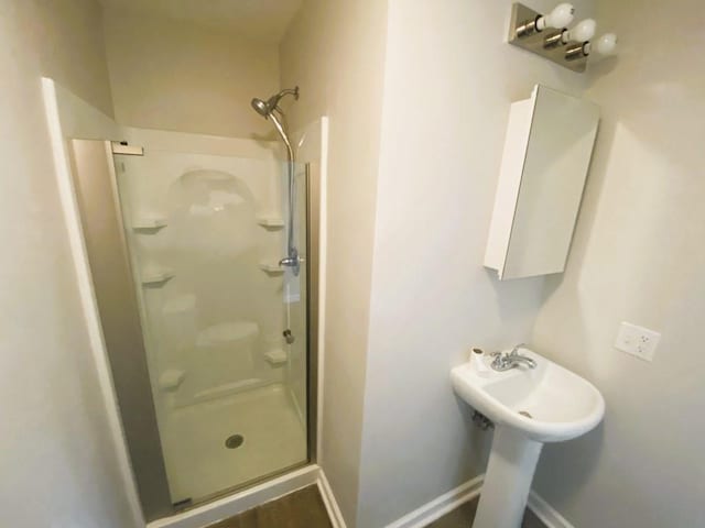 bathroom with a shower with door