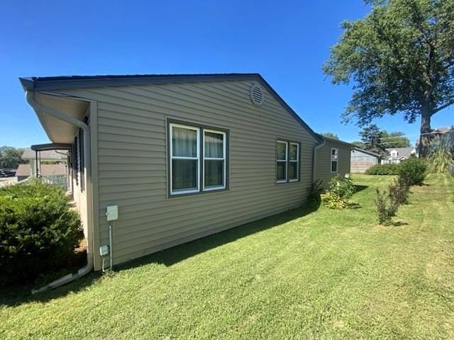 view of side of property featuring a yard