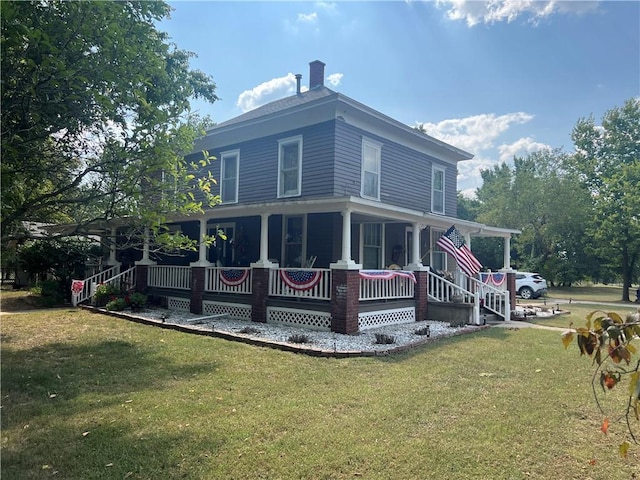 back of house featuring a porch and a yard