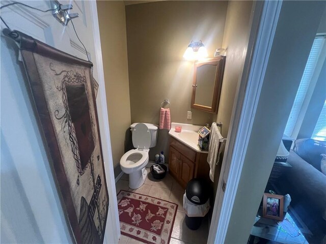 bathroom with tile patterned flooring, toilet, and vanity