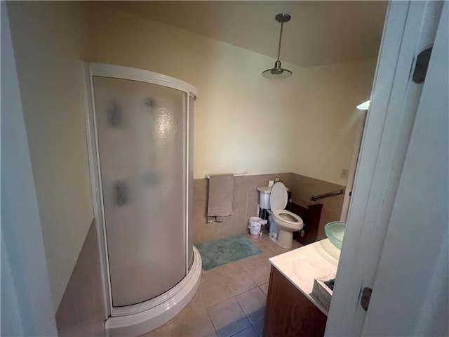 bathroom with vanity, toilet, an enclosed shower, and tile patterned flooring