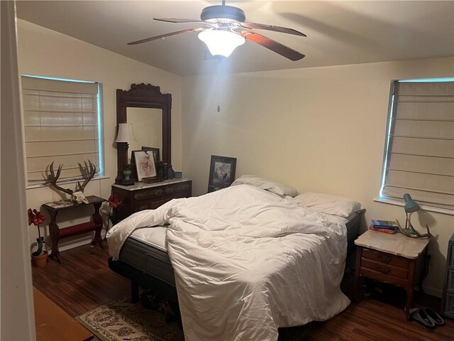 bedroom with dark wood-type flooring, ceiling fan, and vaulted ceiling