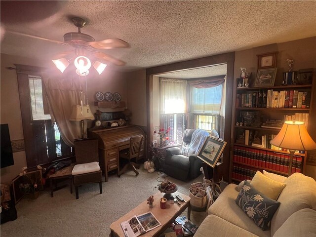 carpeted living room featuring a textured ceiling and ceiling fan