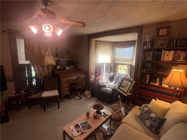 living room featuring a wealth of natural light, ceiling fan, carpet floors, and a textured ceiling