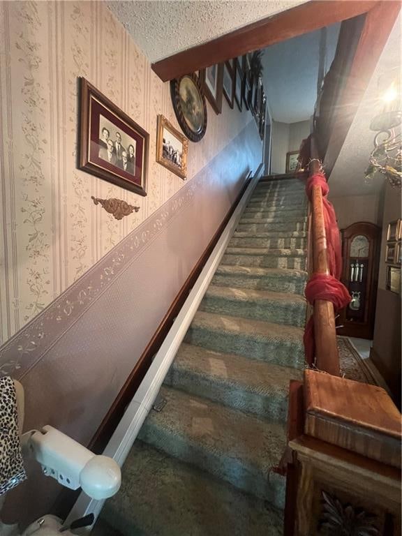 stairs with a textured ceiling