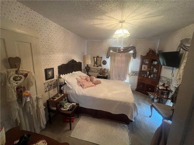 bedroom featuring hardwood / wood-style floors and a textured ceiling