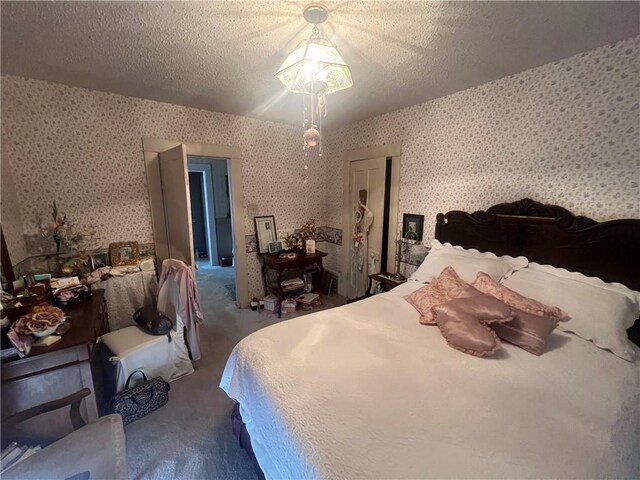 carpeted bedroom featuring a textured ceiling