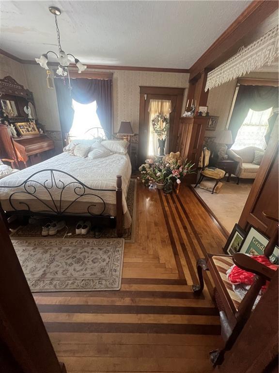 bedroom featuring ornamental molding and an inviting chandelier