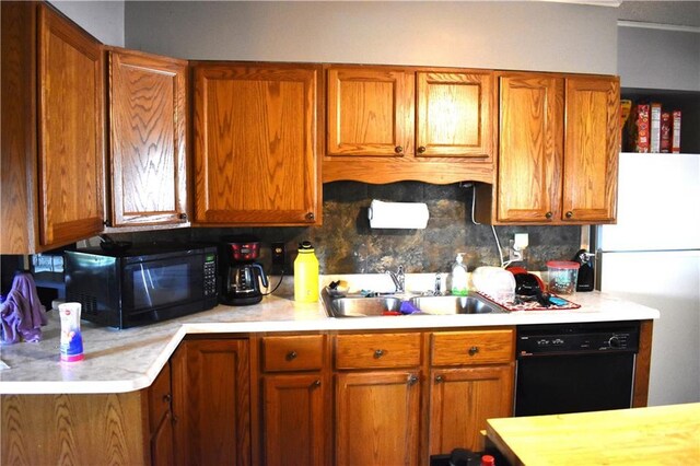 kitchen with black appliances, sink, and tasteful backsplash