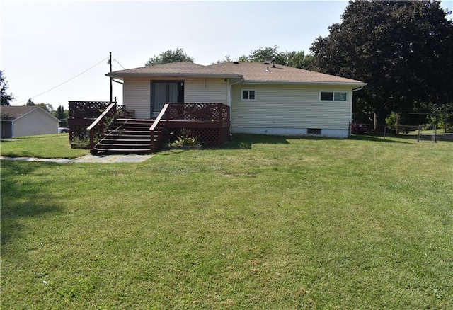 back of house with a wooden deck and a yard