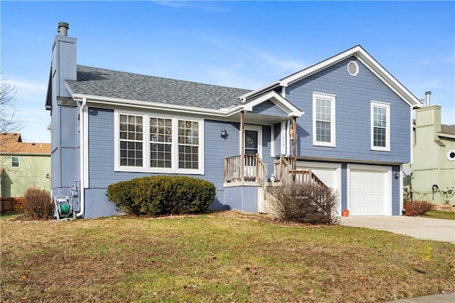 view of front of house with a garage and a front lawn