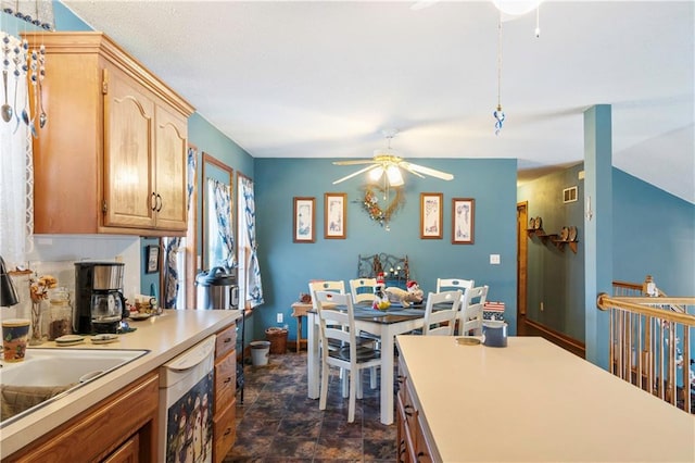 kitchen featuring ceiling fan, light brown cabinets, white dishwasher, and tasteful backsplash