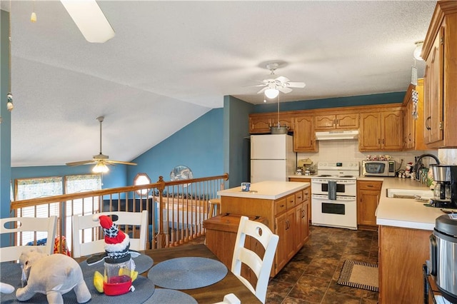 kitchen with white appliances, vaulted ceiling, sink, and ceiling fan