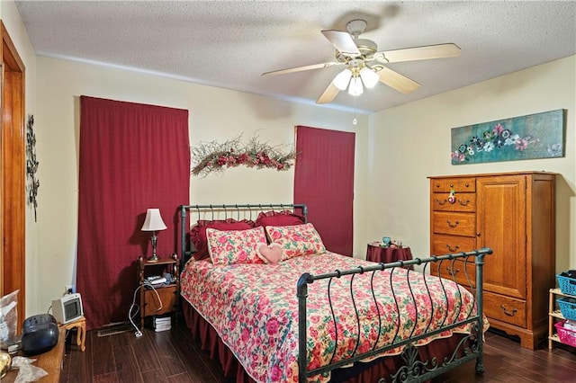 bedroom featuring ceiling fan, dark wood-type flooring, and a textured ceiling