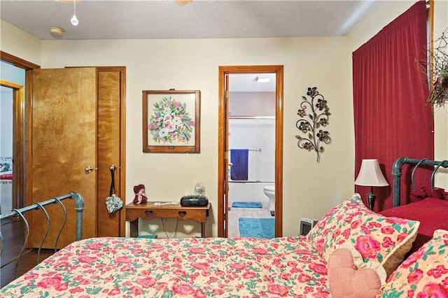 bedroom featuring a textured ceiling and ensuite bathroom