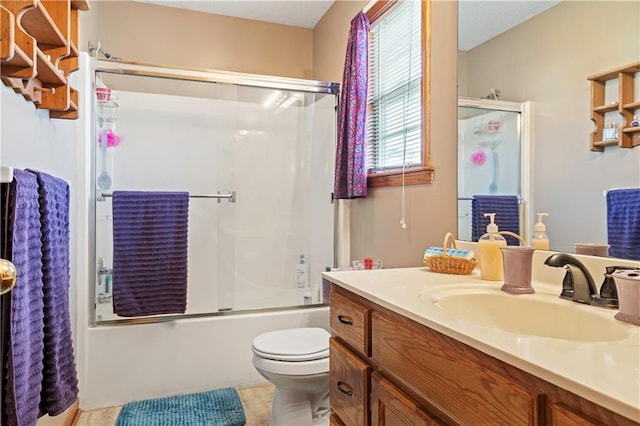 full bathroom featuring tile patterned flooring, toilet, vanity, and combined bath / shower with glass door