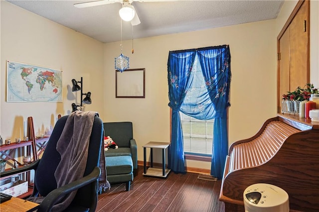 office with ceiling fan, dark hardwood / wood-style floors, and a textured ceiling