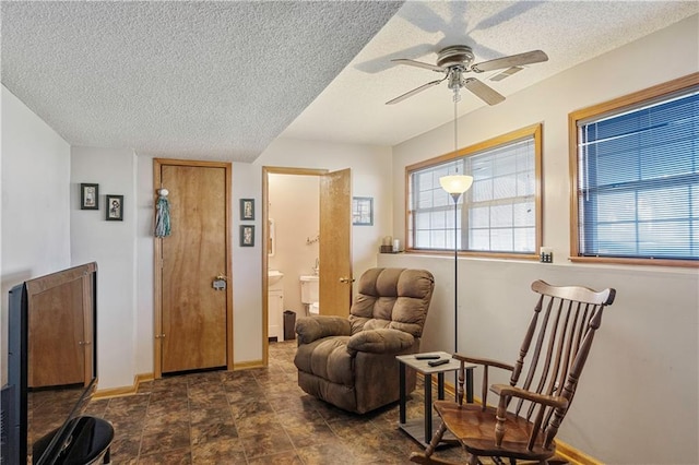 sitting room featuring a textured ceiling and ceiling fan