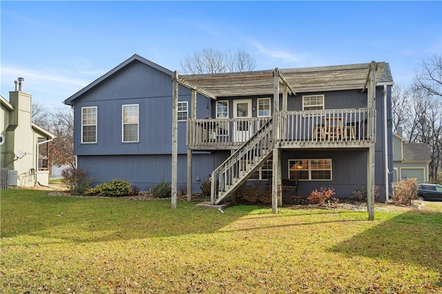 rear view of property with a lawn and a wooden deck