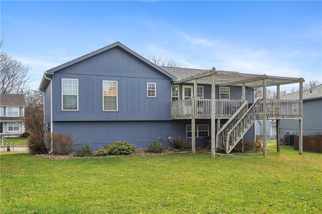 back of house featuring a pergola, a wooden deck, and a lawn