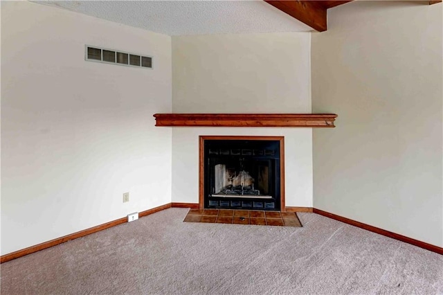 interior details with a textured ceiling, carpet floors, a fireplace with flush hearth, and visible vents