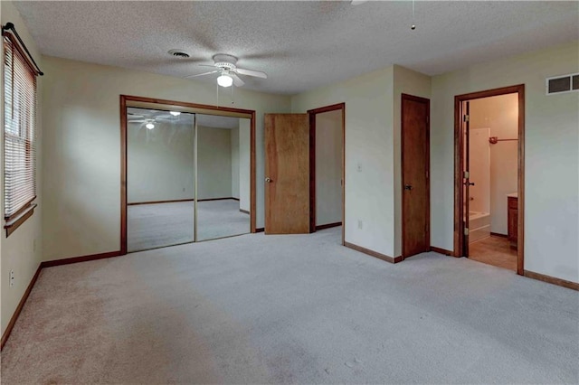 unfurnished bedroom featuring light carpet, visible vents, and baseboards