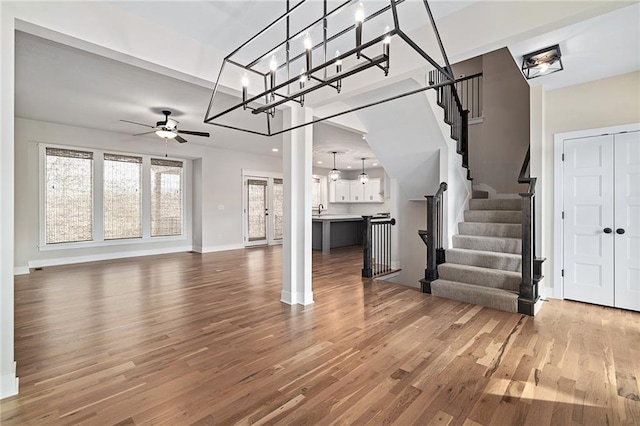 living room featuring hardwood / wood-style floors and ceiling fan with notable chandelier