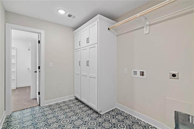 clothes washing area featuring hookup for an electric dryer, cabinets, and washer hookup