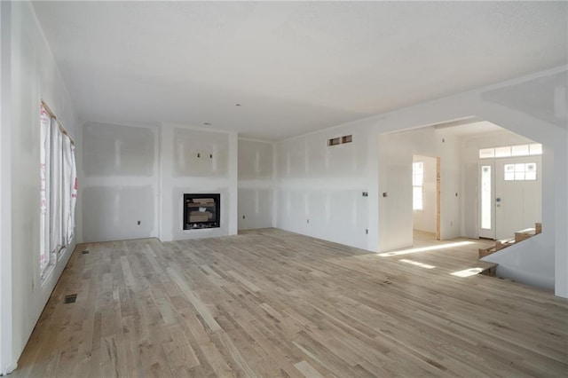 unfurnished living room with light wood-type flooring