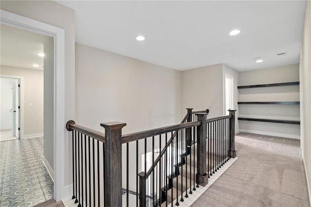 hallway featuring recessed lighting, an upstairs landing, baseboards, and carpet floors