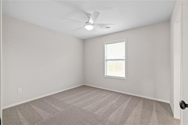 empty room featuring visible vents, baseboards, ceiling fan, and carpet floors