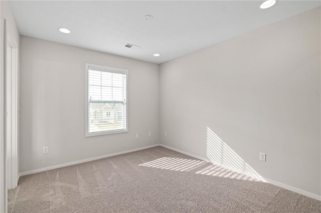 empty room with recessed lighting, carpet, visible vents, and baseboards