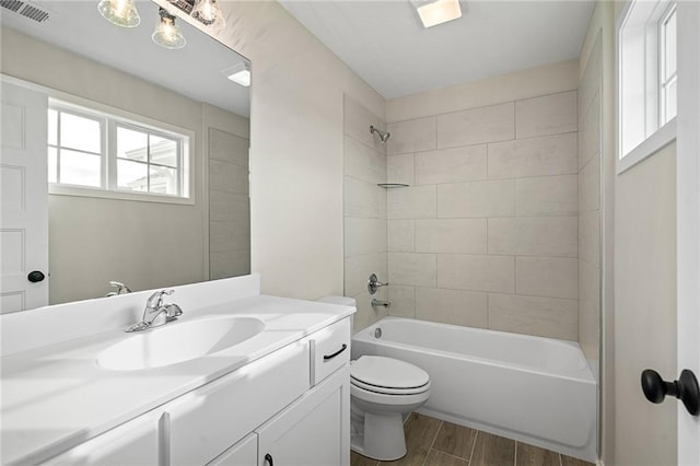 full bath with vanity, visible vents, wood tiled floor, tub / shower combination, and toilet