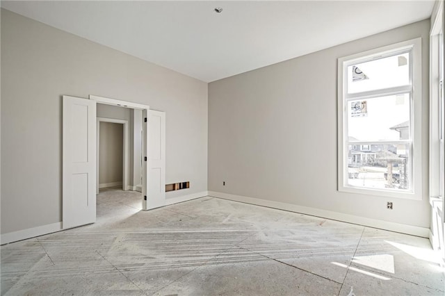 unfurnished room featuring baseboards