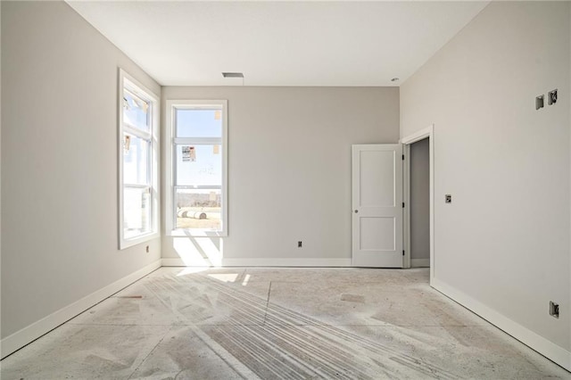unfurnished room with visible vents and baseboards