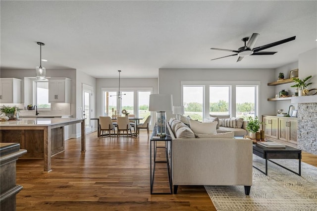 25010 W 142nd St, Olathe, KS 66061 - living area with ceiling fan and dark wood-style flooring
