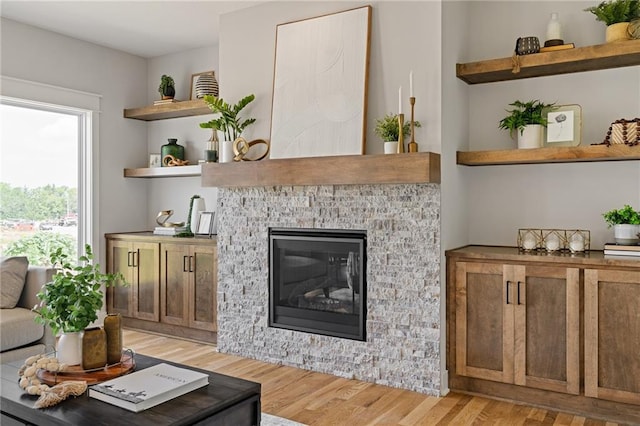 25010 W 142nd St, Olathe, KS 66061 - living area with light wood-style floors and a glass covered fireplace