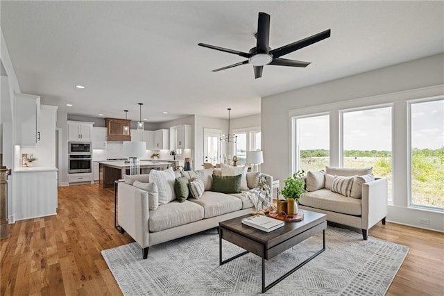25010 W 142nd St, Olathe, KS 66061 - living area with light wood-type flooring, recessed lighting, and ceiling fan