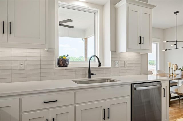 25010 W 142nd St, Olathe, KS 66061 - kitchen with stainless steel dishwasher, white cabinetry, tasteful backsplash, and light countertops