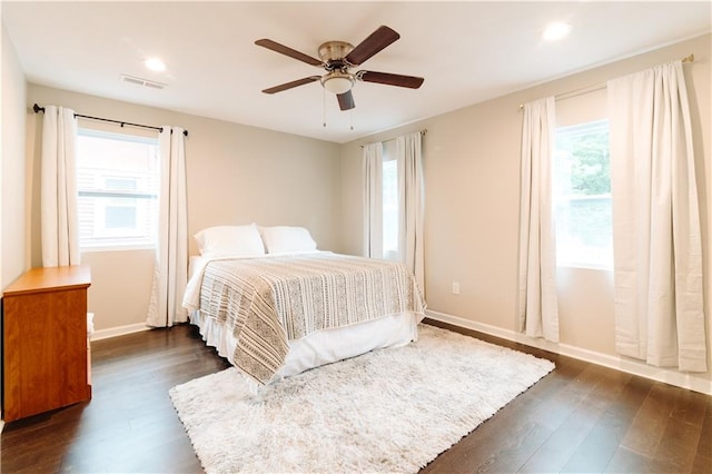 bedroom with ceiling fan and dark hardwood / wood-style flooring