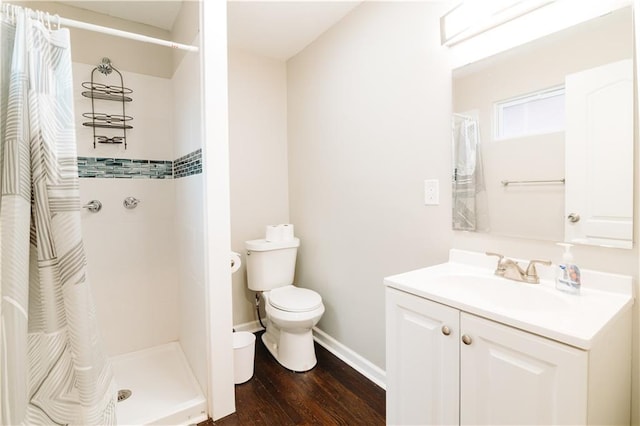 bathroom featuring a shower with curtain, toilet, hardwood / wood-style flooring, and vanity